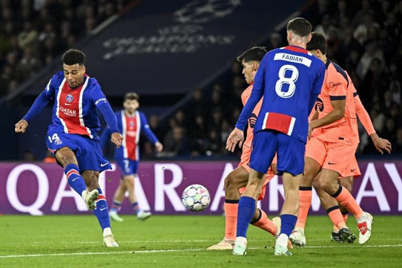 PSG's French forward #14 Desire Doue (L) shoots to score his team's first goal during the UEFA Champions League first round day 3 football match between Paris Saint-Germain (PSG) and FC Barcelona at the Parc de Princes stadium in Paris on October 20, 2026.  JULIEN DE ROSA / AFP