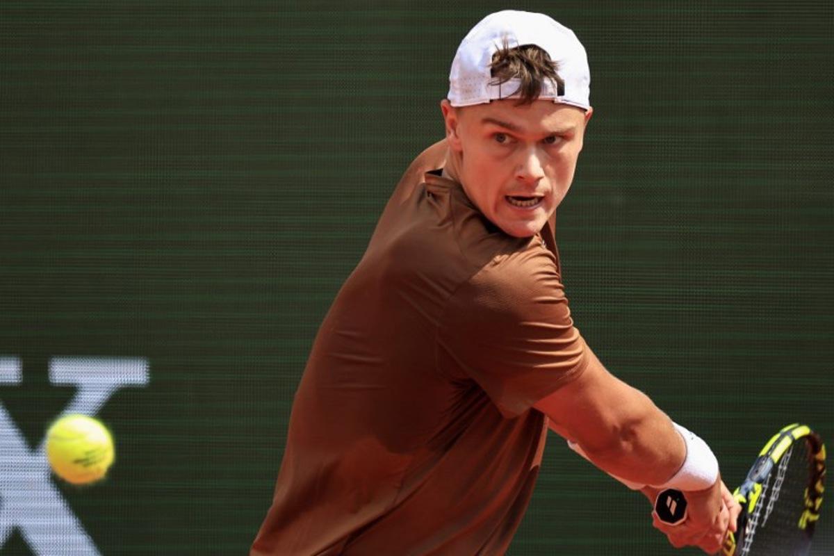 Denmark's Holger Rune plays a backhand return to Portugal's Nuno Borges during the Monte Carlo ATP Masters Series Tournament round of 64 tennis match on the Rainier III court at the Monte Carlo Country Club in Roquebrune-Cap-Martin on April 8, 2025.  Valery HACHE / AFP