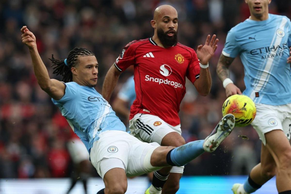 Manchester City's Dutch defender #06 Nathan Ake (L) vies with Manchester United's Cameroonian midfielder #19 Bryan Mbeumo (C) during the English Premier League football match between Manchester United and Manchester City at Old Trafford in Manchester, north west England, on January 17, 2026.  Darren Staples / AFP
