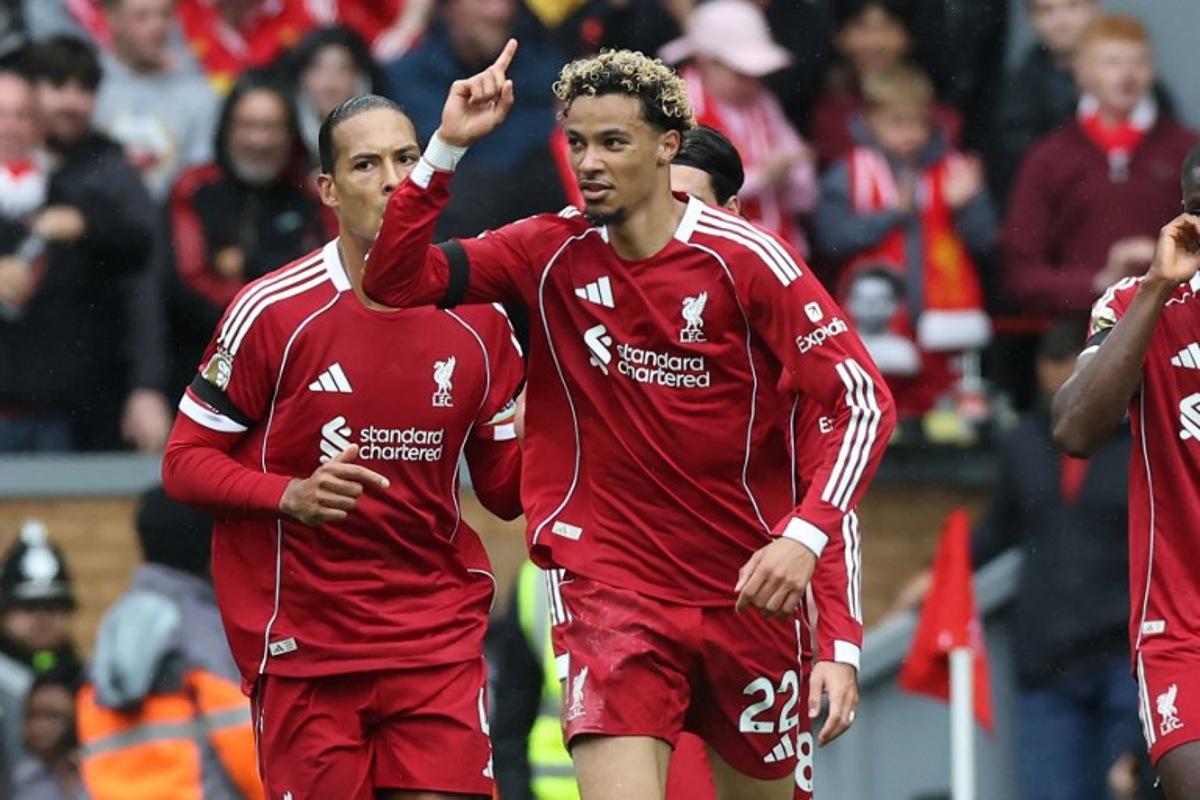 Liverpool's French striker #22 Hugo Ekitike (C) celebrates after scoring their second goal during the English Premier League football match between Liverpool and Everton at Anfield in Liverpool, north west England on September 20, 2025.  Darren Staples / AFP