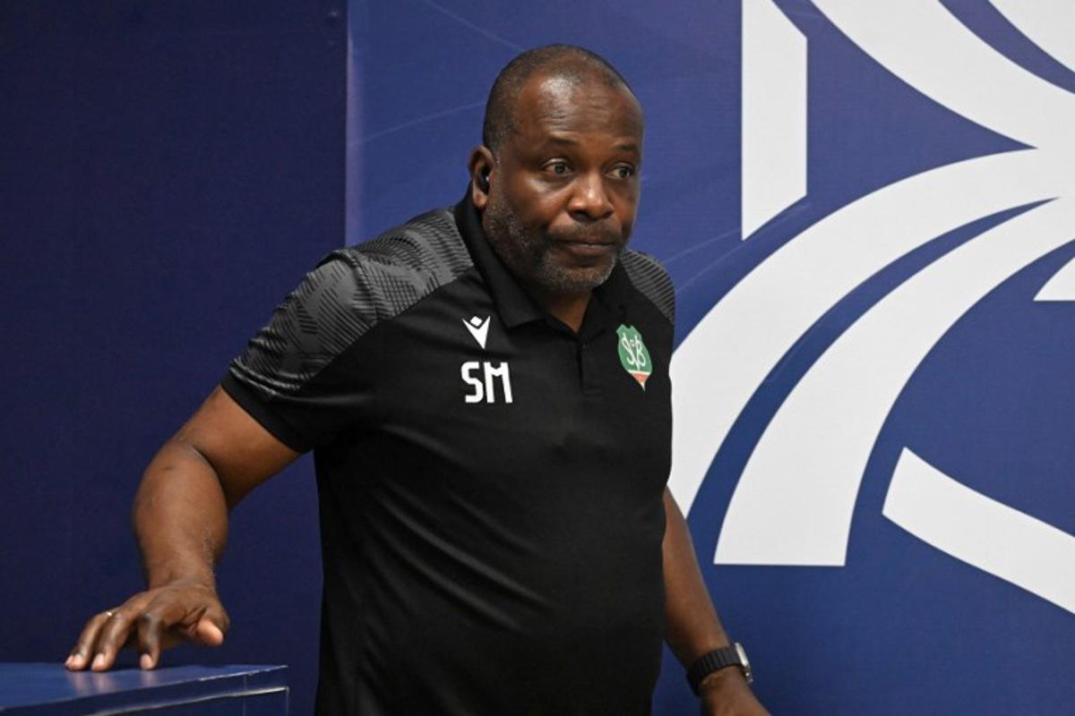 Suriname's head coach Stanley Menzo arrives for a press conference at Manuel Felipe Carrera stadium in Guatemala City on November 17, 2025, ahead of the FIFA World Cup 2026 qualifier football match against Guatemala.  JOHAN ORDONEZ / AFP