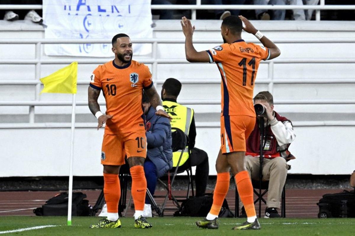 Netherlands' forward #10 Memphis Depay (L) celebrates scoring the opening goal with his teammate Netherlands' forward #11 Cody Gakpo during the 2026 FIFA World Cup Qualifying Group G football match between Finland and the Netherlands in Helsinki on June 7, 2025.  Markku Ulander / LEHTIKUVA / AFP