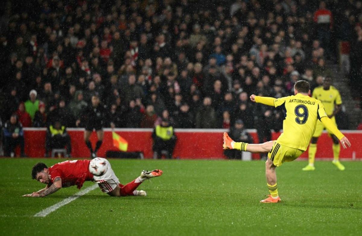 Fenerbahce's Turkish striker #09 Muhammed Kerem Akturkoglu shoots past Nottingham Forest's Welsh defender #03 Neco Williams to score the opening goal during the UEFA Europa League Knockout Round Play-off second-leg football match between Nottingham Forest and Fenerbahce SK at The City Ground in Nottingham, central England, on February 26, 2026.  Oli SCARFF / AFP