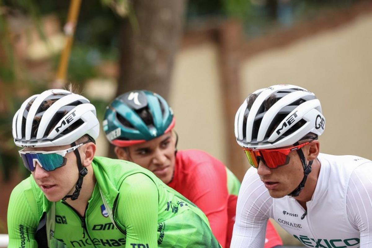 Slovenian rider Tadej Pogacar (L) and Mexican rider Isaac del Toro (R) cycle during a training session during the UCI 2025 Road World Championships, in Kigali, on September 24, 2025.  Anne-Christine POUJOULAT / AFP