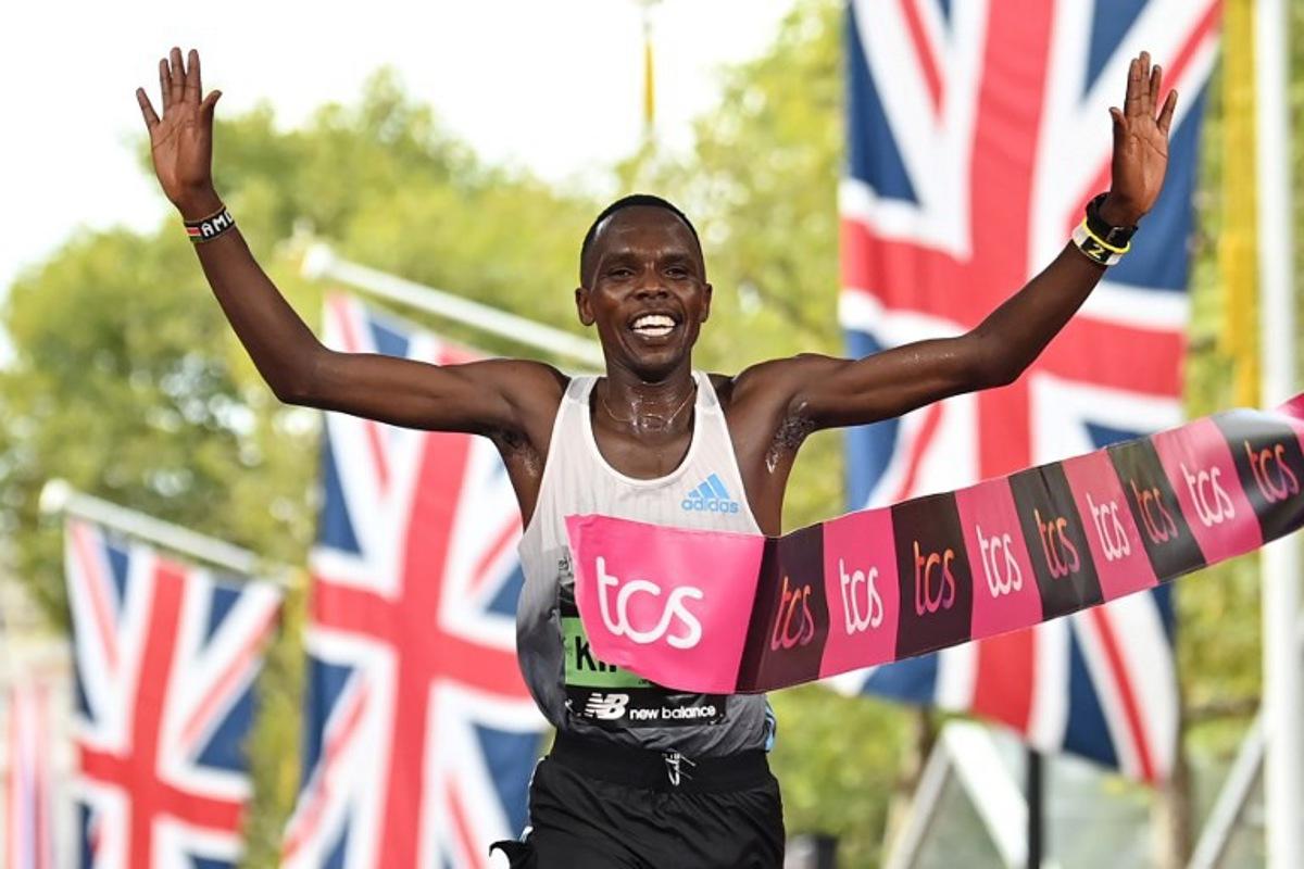 Kenya's Amos Kipruto breaks the tape to win the men's race at the finish of the 2022 London Marathon in central London on October 2, 2022.  Glyn KIRK / AFP