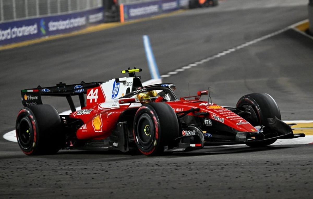 Ferrari's British driver Lewis Hamilton drives during the Formula One Singapore Grand Prix at the Marina Bay Street Circuit in Singapore on October 11, 2026.  ROSLAN RAHMAN / AFP