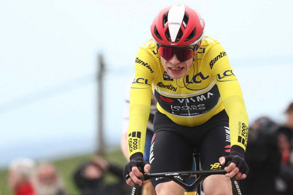 Team Visma-Lease a Bike's Danish rider Jonas Vingegaard wearing the overall leader's yellow jersey reacts as he crosses the finish line of the 5th stage of the Paris-Nice cycling race, 203,3 km between Saint-Just-en-Chevalet and La Côte-Saint-André, on March 13, 2025.  Anne-Christine POUJOULAT / AFP