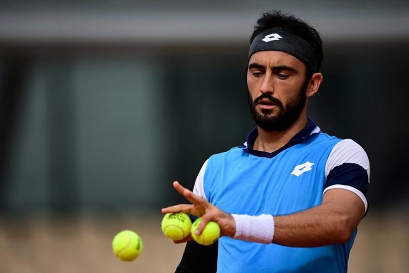 Italy's Lorenzo Giustino reacts as he plays against Argentina's Diego Schwartzman during their men's singles second round tennis match on Day 4 of The Roland Garros 2020 French Open tennis tournament in Paris on September 30, 2020.  MARTIN BUREAU / AFP