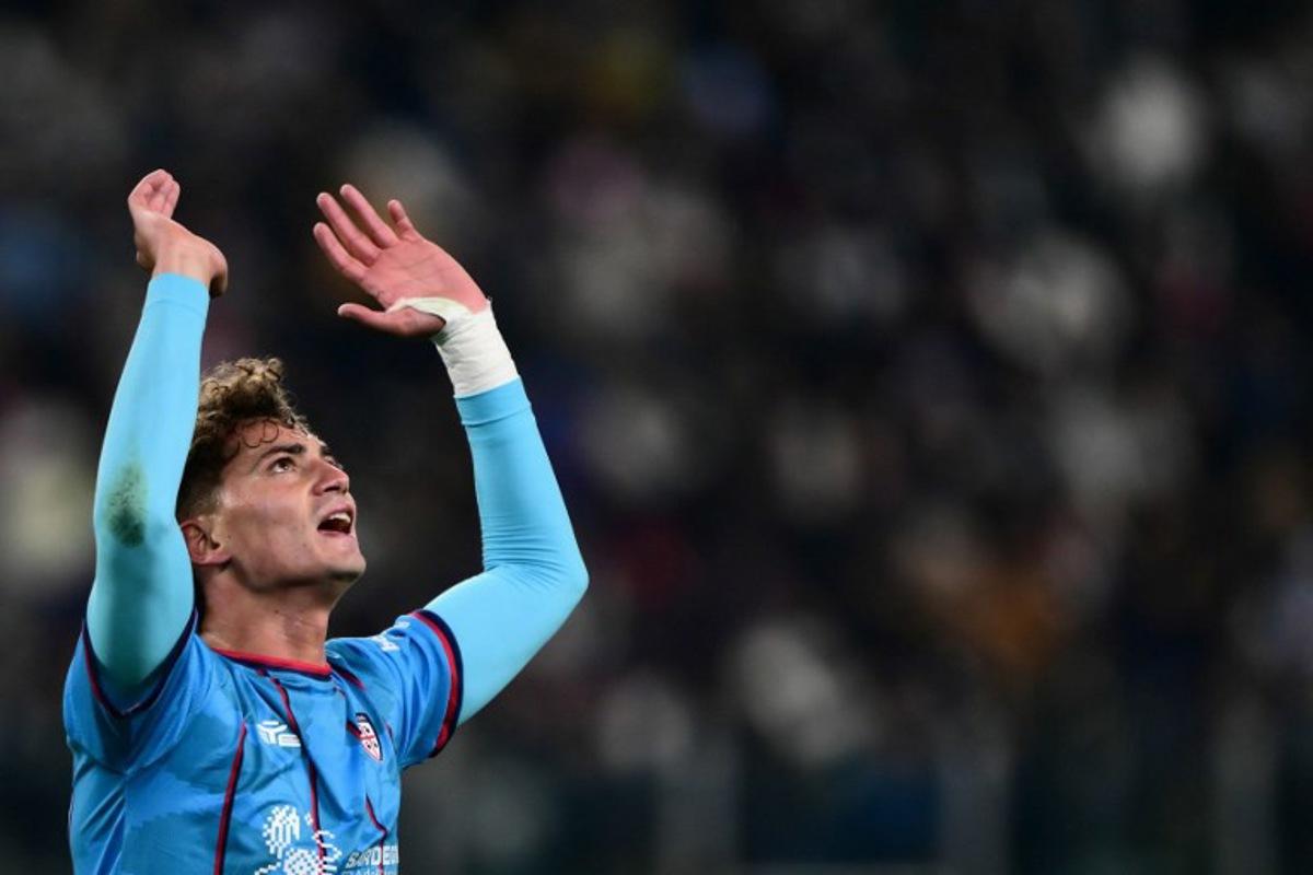 Cagliari's Italian forward #94 Sebastiano Esposito celebrates after scoring his team first goal during the Italian Serie A football match between Juventus and Cagliari at the Allianz Stadium, in Turin, northern Italy, on November 29, 2025.  MARCO BERTORELLO / AFP