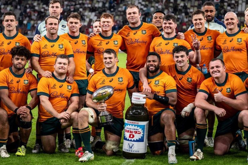 Australia players pose with the trophy after their victory against Japan in their international rugby union Test match at the National Stadium in Tokyo on October 25, 2025.  Philip FONG / AFP