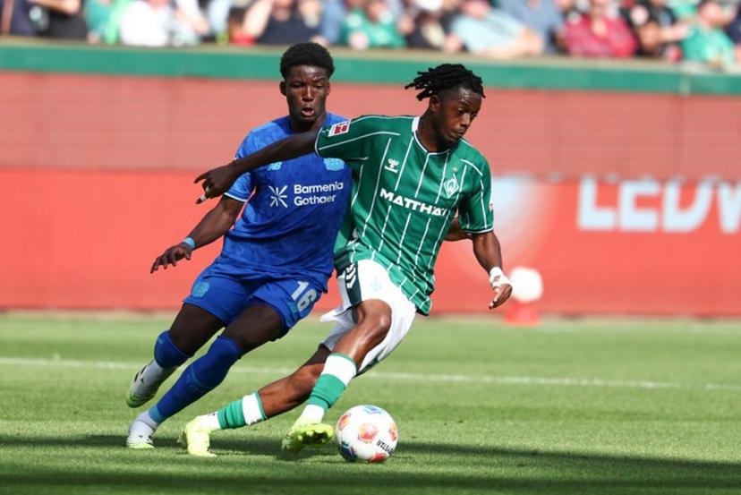 Bayer Leverkusen's French defender #16 Axel Tape (L) and Bremen's Belgian midfielder #07 Samuel Mbangula vie for the ball during the German first division Bundesliga football match between Werder Bremen and Bayer Leverkusen in Bremen on August 30, 2025.  Ibrahim OT / AFP