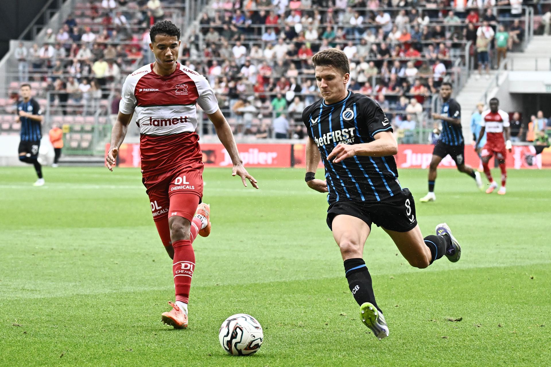 Essevee's Laurent Lemoine and Club's Christos Tzolis fight for the ball during a soccer match between Zulte Waregem and Club Brugge, Saturday 16 August 2025 in Waregem, on day 4 of the 2025-2026 'Jupiler Pro League' first division of the Belgian championship. BELGA PHOTO MAARTEN STRAETEMANS