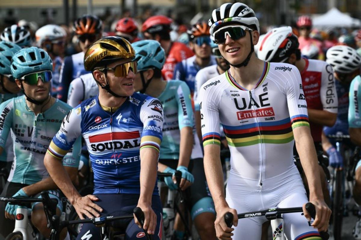 Soudal Quick-Step team's Belgian rider Remco Evenepoel (L) speaks with UAE Team Emirates team's Slovenian rider Tadej Pogacar (R) before the start of 118th edition of the Giro di Lombardia (Tour of Lombardy), a 252km cycling race from Bergamo to Como on October 12, 2024.  Marco BERTORELLO / AFP