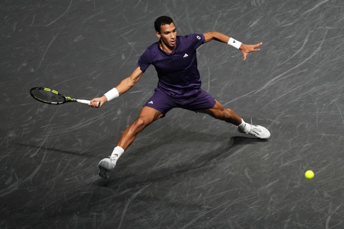 Canada's Felix Auger-Aliassime plays a forehand return to Italy's Jannik Sinner during their men's singles final match on day seven of the Paris ATP Masters 1000 tennis tournament at the Paris La Défense Arena in Nanterre, on the outskirts of Paris, on November 2, 2025.  Dimitar DILKOFF / AFP