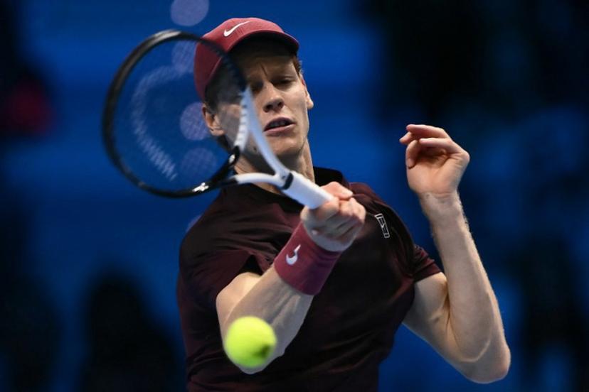 Italy's Jannik Sinner hits a return against USA's Ben Shelton during their match at the ATP Finals tennis tournament in Turin on November 14, 2025.  Marco BERTORELLO / AFP