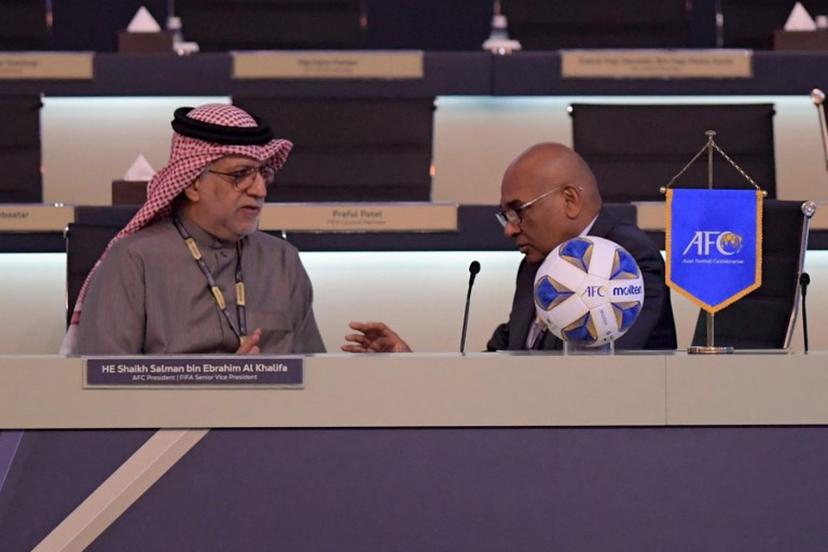 AFC President Salman bin Ibrahim al-Khalifa (L) speaks with AFC General Secretary Datuk Seri Windsor John during the 33rd Asian Football Confederation (AFC) Congress at the Gulf Convention Centre in Manama on February 1, 2023.  Mazen Mahdi / AFP