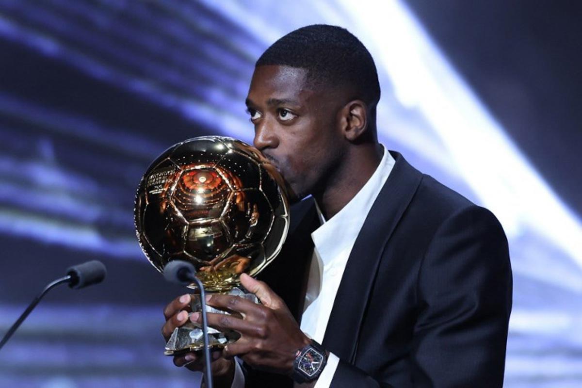 Paris Saint-Germain's French forward Ousmane Dembele kisses the Ballon d'Or award during the 2025 Ballon d'Or France Football award ceremony at the Theatre du Chatelet in Paris on September 22, 2025.  Franck FIFE / AFP