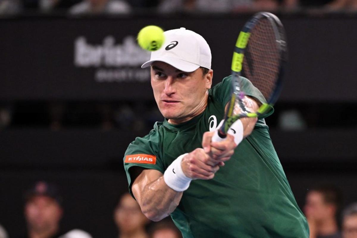 Belgium's Raphael Collignon hits a return to Bulgaria's Grigor Dimitrov during their men's singles match at the Brisbane International tennis tournament in Brisbane on January 8, 2026.  William WEST / AFP