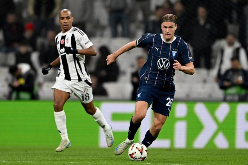 Malmo's  Lasse Berg Johnsen (R) fights for the ball with Besiktas' Joao Mário (L) during the UEFA Europa League league phase day 4 football match between Besiktas JK and Malmö at the Besiktas Park Stadium in Istanbul on November 6, 2024.  Ozan KOSE / AFP