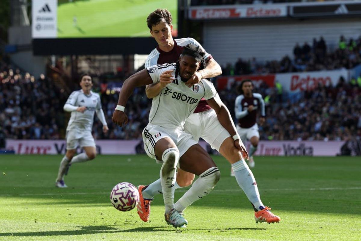 Aston Villa's Spanish defender #14 Pau Torres (R) vies with Fulham's Spanish midfielder #11 Adama Traore during the English Premier League football match between Aston Villa and Fulham at Villa Park in Birmingham, central England on September 28, 2025.  Darren Staples / AFP