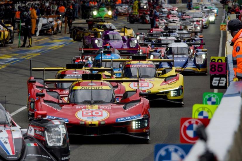 Drivers prepare to take the start of the 24 Hours of Le Mans endurance race, which is part of the FIA World Endurance Championship (WEC), in Le Mans, Western France, on June 15, 2024.   GUILLAUME SOUVANT / AFP