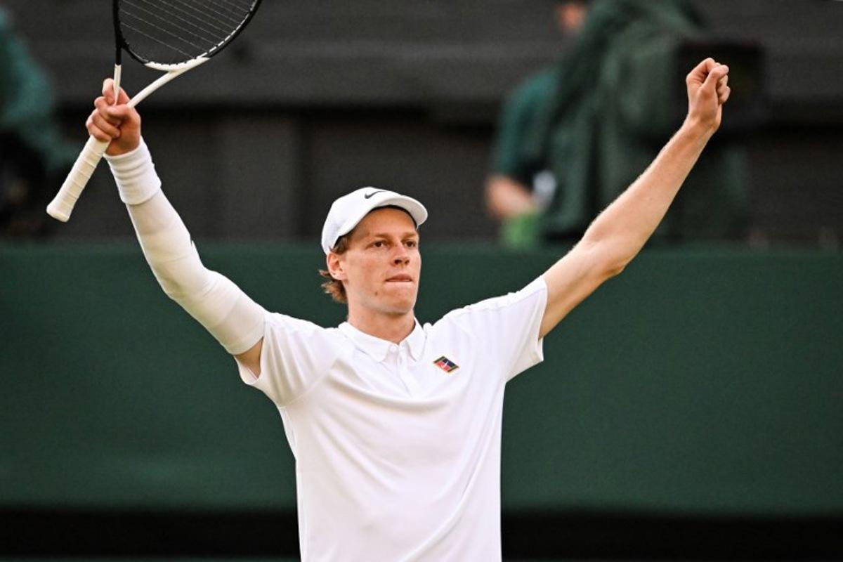 Italy's Jannik Sinner celebrates after victory against Spain's Carlos Alcaraz at the end of their men's singles final tennis match on the fourteenth day of the 2025 Wimbledon Championships at The All England Lawn Tennis and Croquet Club in Wimbledon, southwest London, on July 13, 2025.  Kirill KUDRYAVTSEV / AFP