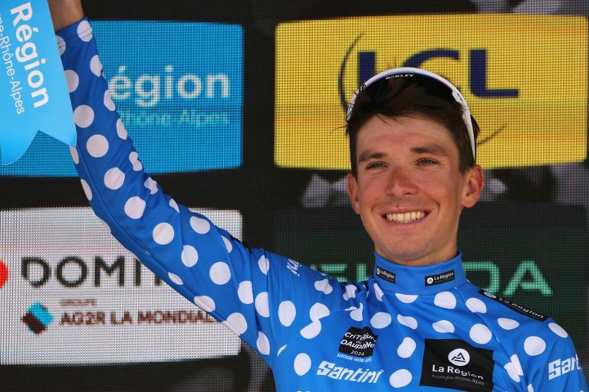 Team Astana's Italian rider Lorenzo Fortunato celebrates with the climber's dotted jersey on the podium after the eighth and last stage of the 76th edition of the Criterium du Dauphine cycling race, 160,6km between Thones and Plateau des Glieres, near Thorens-Glieres, French Alps, on June 9, 2024.  Thomas SAMSON / AFP
