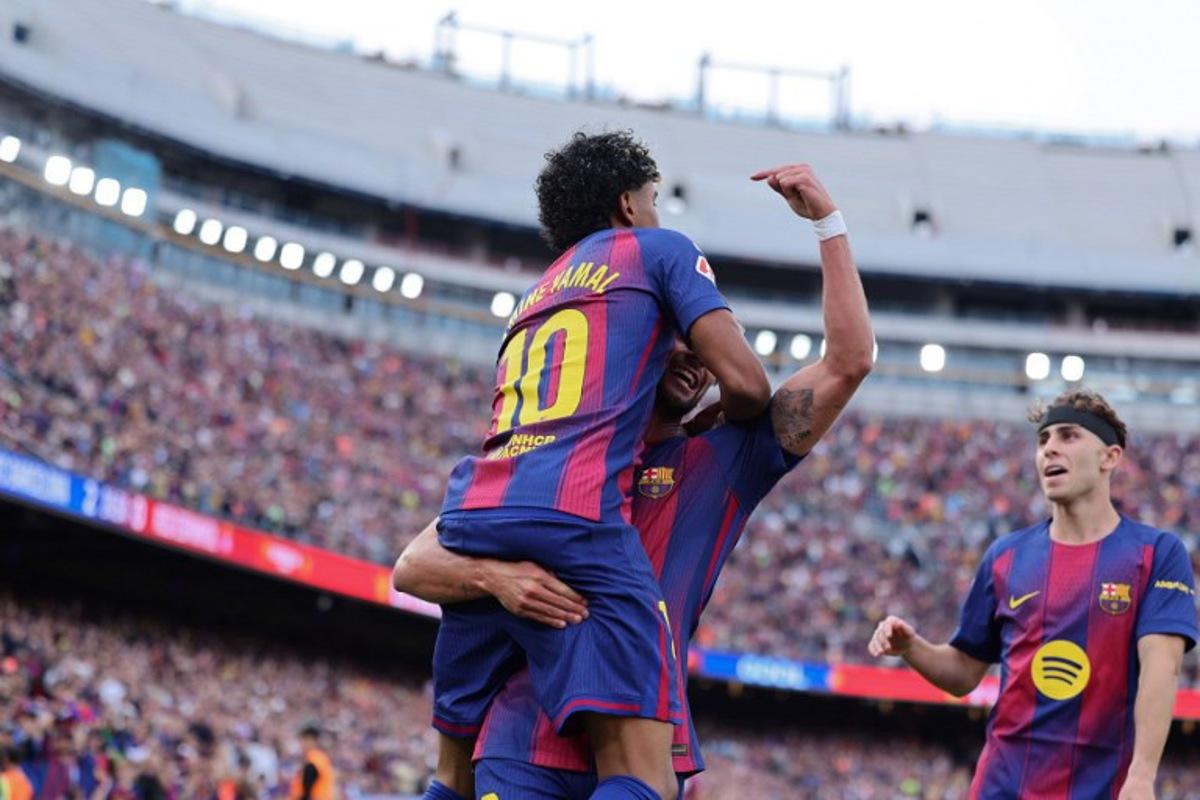 Barcelona's Spanish forward #07 Ferran Torres celebrates with Barcelona's Spanish forward #10 Lamine Yamal scoring his team's second goal during the Spanish league football match between FC Barcelona and RCD Espanyol at the Camp Nou stadium in Barcelona on April 11 , 2026.  Josep LAGO / AFP