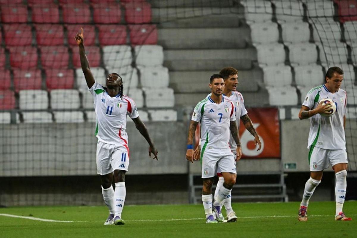 Italy's forward #11 Moise Kean (L) celebrates after scoring the equalizing 1-1 goal during the 2026 World Cup qualifiers Europe zone group I football match between Israel and Italy on September 8, 2025 in Debrecen, Hungary.  Attila KISBENEDEK / AFP