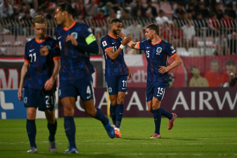 Netherlands' forward #11 Cody Gakpo (C) celebrates with Netherlands' defender #15 Micky van de Ven (R) after succesfully converting a penalty to score the Netherlands' first goal during the FIFA World Cup 2026 Group G qualification football between Malta and Netherlands at the National Stadium in Ta' Qali, on October 9, 2025.  Alberto PIZZOLI / AFP
