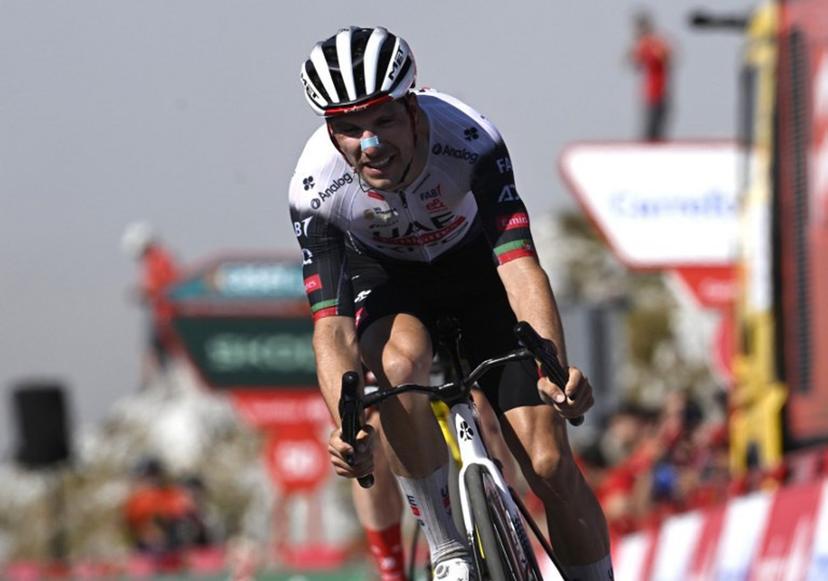 Team UAE's Portuguese rider Joao Almeida crosses first the finish line of the 13th stage of the Vuelta a Espana, a 202 km race between Cabezon de la Sal and L'Angliru, on September 5, 2025.    Miguel RIOPA / AFP