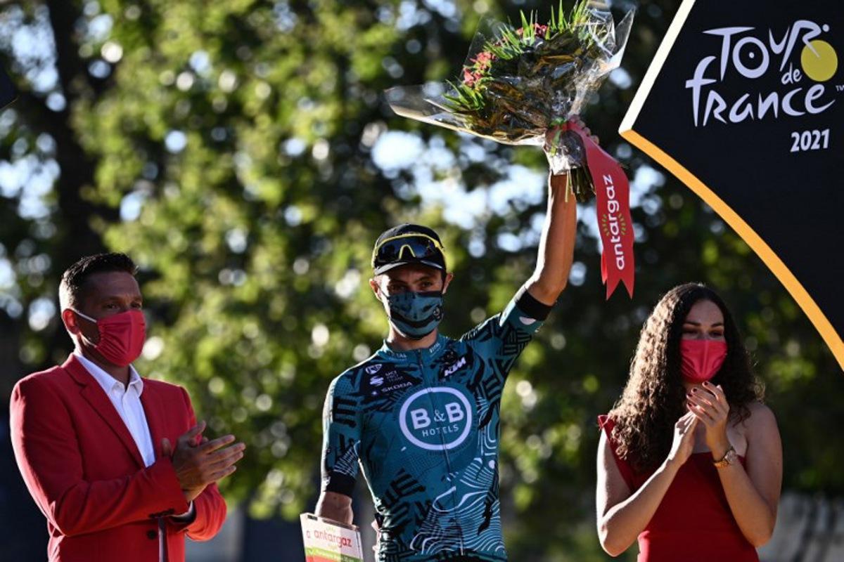 Team B&B KTM's Franck Bonnamour of France celebrates on the podium his super combative price at the end of the 21th and last stage of the 108th edition of the Tour de France cycling race, 108 km between Chatou and Paris Champs-Elysees, on July 18, 2021.  Anne-Christine POUJOULAT / AFP