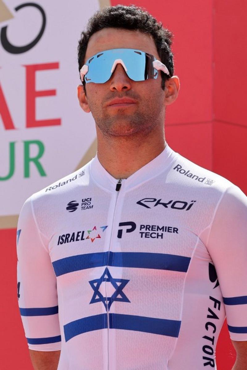 Israeli cyclist Itamar Einhorn of the Israel-Premier Tech Team poses for a photo before the start of the first stage of the UAE cycling tour from al-Dhafra Castle to Qassar al-Mighayra St in al-Mirfa in the emirate of Abu Dhabi on February 20, 2023.  Giuseppe CACACE / AFP