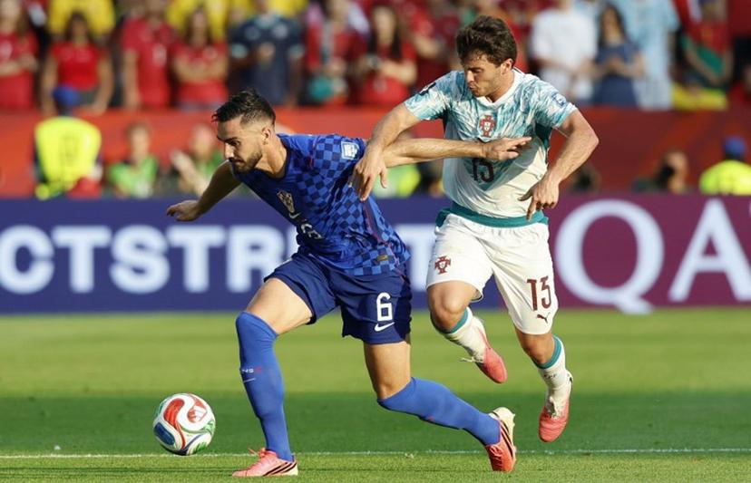 Croatia's defender #06 Josip Sutalo and Portugal's midfielder #15 Joao Neves fight for the ball during the 2026 World Cup round of 32 football match between Portugal and Croatia at the Toronto Stadium in Toronto on July 2, 2026.   Kamil Krzaczynski / AFP