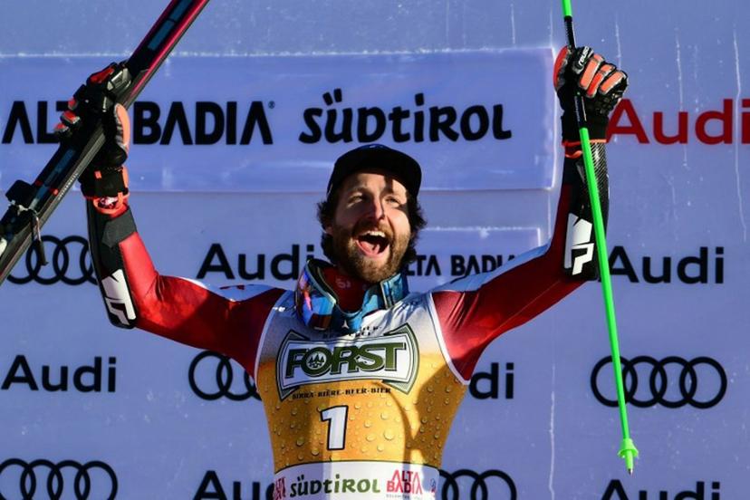 Race winner Austria's Marco Schwarz celebrates on the podium after competing in the men's giant slalom part of the FIS Alpine Ski World Cup 2025-2026, in Alta Badia, northern Italy, on December 21, 2025.  Stefano RELLANDINI / AFP