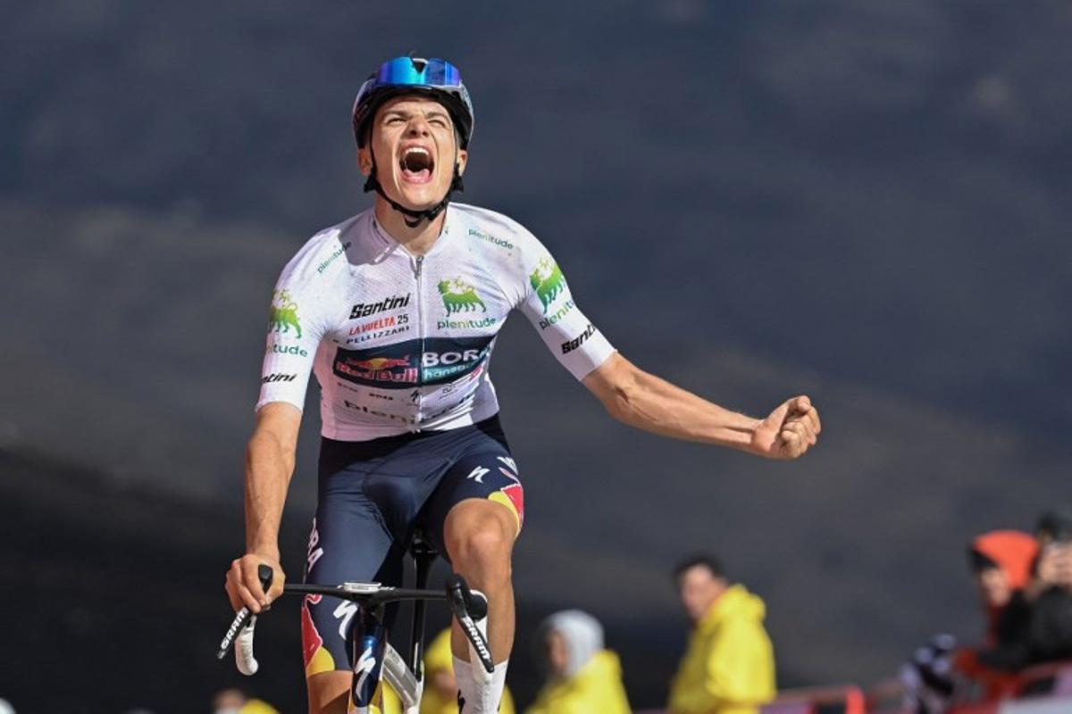 Team Bora's Italian rider Giulio Pellizzari celebrates as he crosses the finish line to win the 17th stage of the Vuelta a Espana, a 143 km race between  O Barco de Valdeorras and Alto de El Morredero, Ponferrada, on September 10, 2025.    Miguel RIOPA / AFP