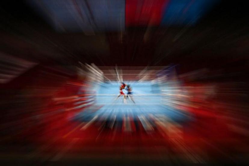 Kazakhstan's Saken Bibossinov (red) and Puerto Rico's Yankiel Rivera Figueroa fight during their men's fly (48-52kg) preliminaries boxing match during the Tokyo 2020 Olympic Games at the Kokugikan Arena in Tokyo on July 26, 2021.   Luis ROBAYO / AFP