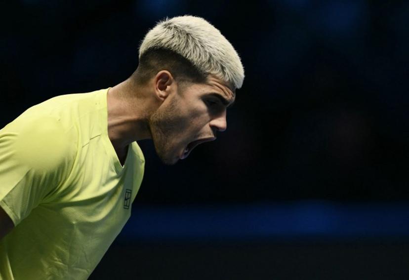Spain's Carlos Alcaraz reacts during the match against USA's Taylor Fritz during the ATP Finals tennis tournament in Turin on November 11, 2025.  Marco BERTORELLO / AFP