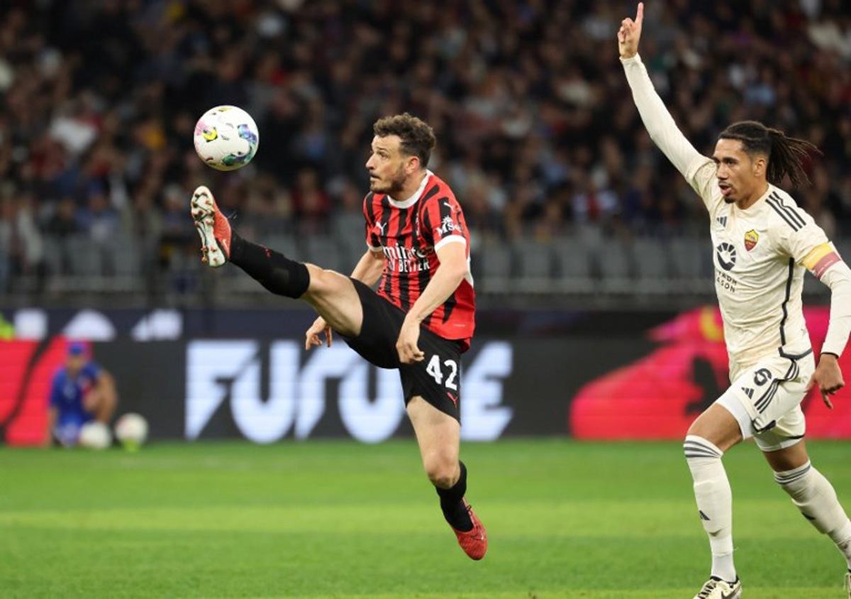 AC Milan's Alessandro Florenzi (L) kicks the ball as AS Roma's Chris Smalling gestures during a friendly match between AC Milan and AS Roma at the Perth Rectangular Stadium in Perth on May 31, 2024.   COLIN MURTY / AFP