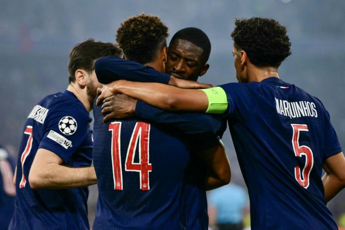 Paris Saint-Germain's French midfielder #14 Desire Doue celebrates after scoring with teammates Georgian forward #07 Khvicha Kvaratskhelia (L), French forward #10 Ousmane Dembele (3rd L) and Brazilian defender #05 Marquinhos during the UEFA Champions League final football match between Paris Saint-Germain (PSG) and Inter Milan in Munich, southern Germany on May 31, 2025.  Marco BERTORELLO / AFP