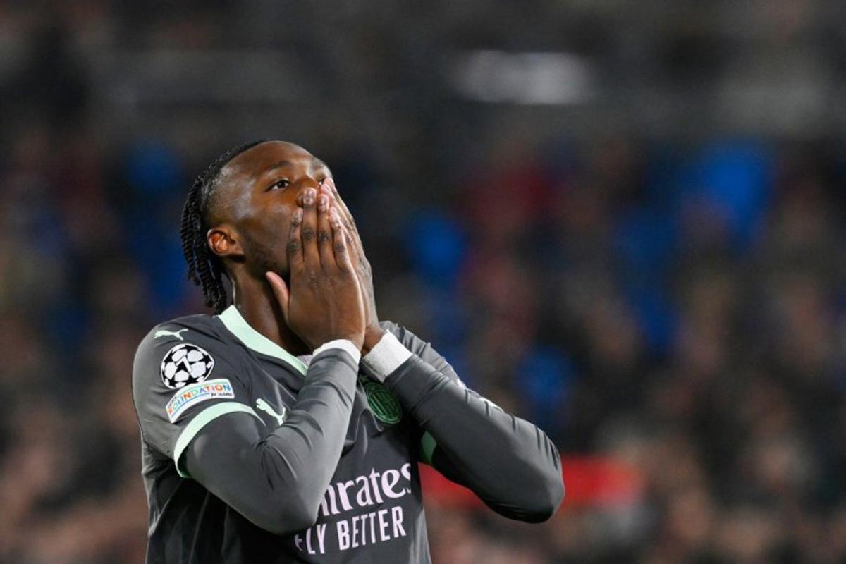 AC Milan's English forward #90 Tammy Abraham reacts  during the UEFA Champions League knockout phase play-off 1st leg football match between Feyenoord Rotterdam and AC Milan at the Stadion Feijenoord "De Kuip" in Rotterdam, on February 12, 2025.   JOHN THYS / AFP