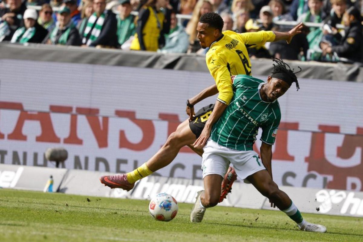 Bremen's Belgian midfielder #07 Samuel Mbangula and Dortmund's German midfielder #08 Felix Nmecha vie for the ball during the German first division Bundesliga football match between Werder Bremen and Borussia Dortmund in Bremen, northwestern Germany, on May 16, 2026.  Focke Strangmann / AFP