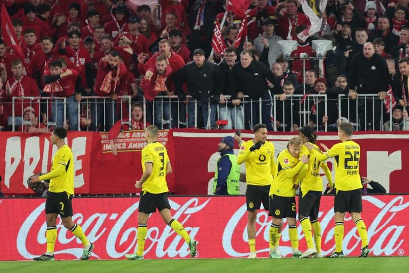 Dortmund's English midfielder #07 Jobe Bellingham (L) celebrates scoring with his teammates before the goal was disallowed for offside by VAR during the German first division Bundesliga football match between FC Bayern Munich and BVB Borussia Dortmund in Munich, southern Germany, on October 31, 2026. Alexandra BEIER / AFP