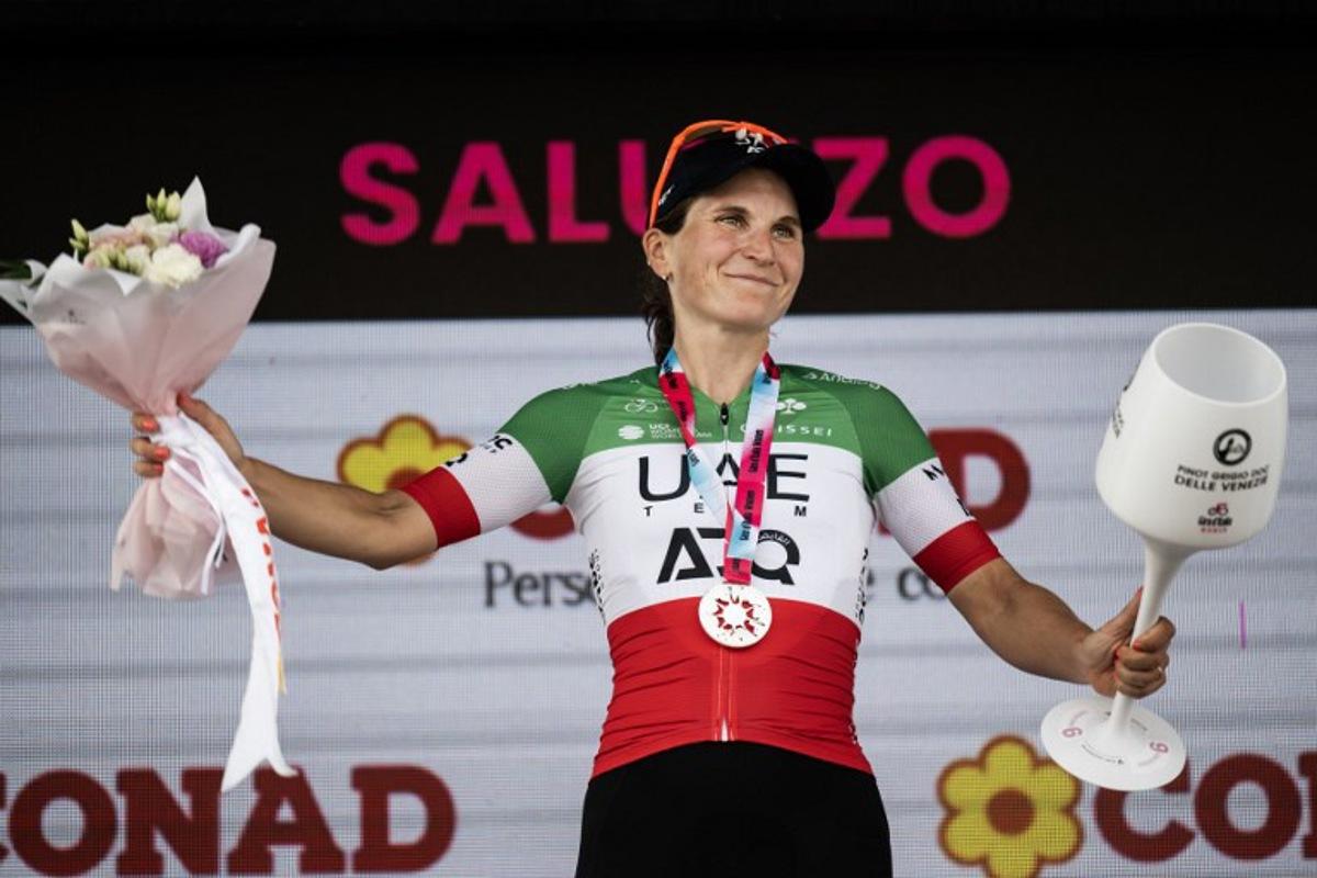 UAE Italian rider Elisa Longo Borghini poses on the podium after winning the 9th stage of the Giro d'Italia Women 2026 - Tour of Italy Women cycling race between Saluzzo and Saluzzo, Italy, on June 7, 2026. MARCO BERTORELLO / AFP