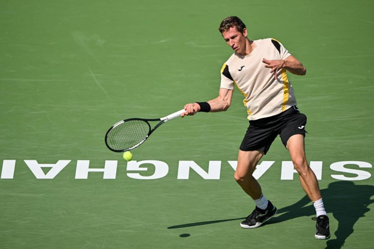 Belgium's Kimmer Coppejans hits a return to Greece's Stefanos Tsitsipas during their men's singles match at the Shanghai Masters tennis tournament in Shanghai on October 8, 2026. Hector RETAMAL / AFP