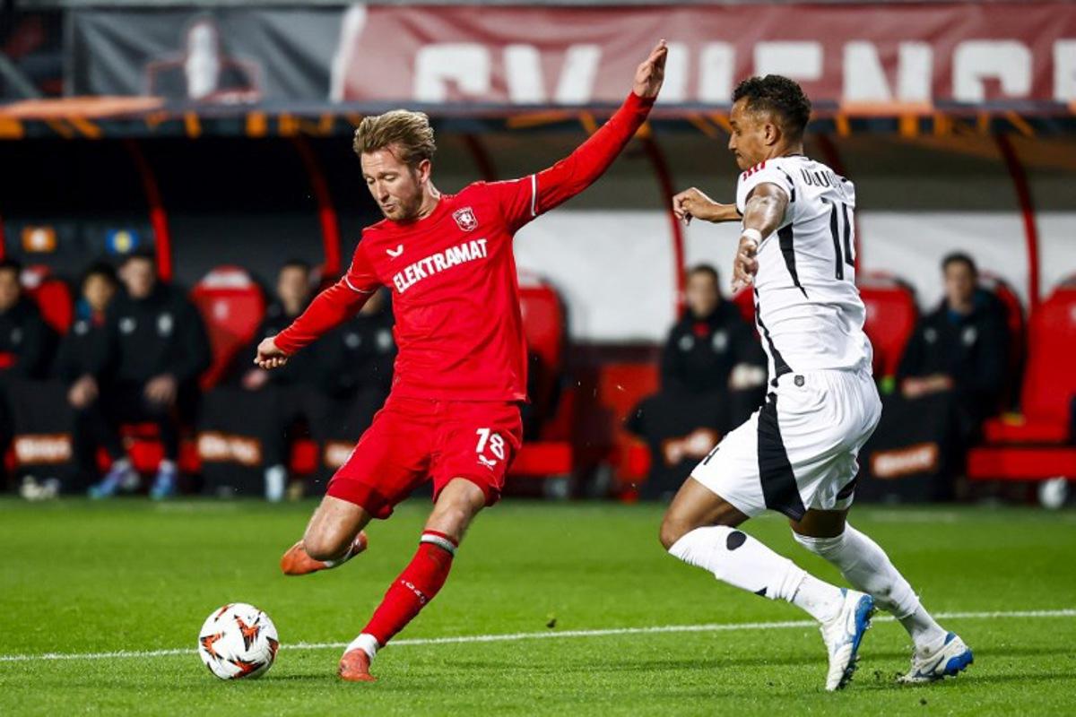 Besiktas' German defender #14 Ohis Felix Uduokhai challenges FC Twente's Dutch midfielder #18 Michel Vlap (L) during the UEFA Europa League, 1st round day 8, football match between FC Twente and Besiktas at De Grolsch Veste stadium in Enschede, eastern Netherlands, on January 30, 2025. Vincent Jannink / ANP / AFP
