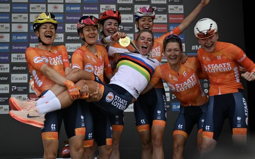 First-placed Demi Vollering of the Netherlands and teammtaes celebrate on the podium after the Women's Elite Road Race at the 2026 Union Cycliste Internationale (UCI) Road World Championships in Montreal, Quebec, on September 26, 2026. Andrej Ivanov / AFP