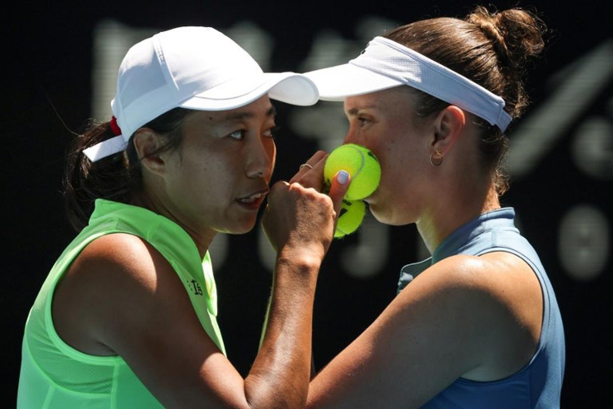 China's Zhang Shuai (L) talks to partner Belgium's Elise Mertens during their women's doubles final match against Kazakhstan's Anna Danilina and Serbia's Aleksandra Krunic on day fourteen of the Australian Open tennis tournament in Melbourne on January 31, 2026. DAVID GRAY / AFP