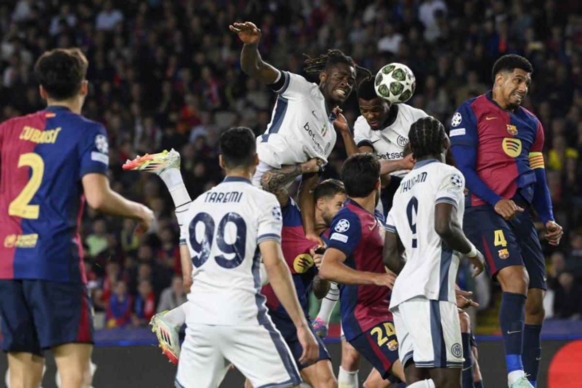 Inter Milan's Dutch defender #02 Denzel Dumfries (C,R) scores his team's third goal during the UEFA Champions League semi final first leg football match between FC Barcelona and Inter Milan at the Estadi Olimpic Lluis Companys in Barcelona on April 30, 2025. Josep LAGO / AFP