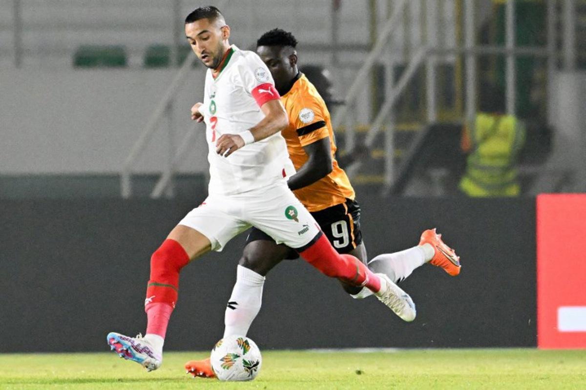 Morocco's midfielder #7 Hakim Ziyech (L) fights for the ball with with Zambia's forward #9 Lameck Banda during the Africa Cup of Nations (CAN) 2024 group F football match between Zambia and Morocco at the Stade Laurent Pokou in San Pedro on January 24, 2024. SIA KAMBOU / AFP